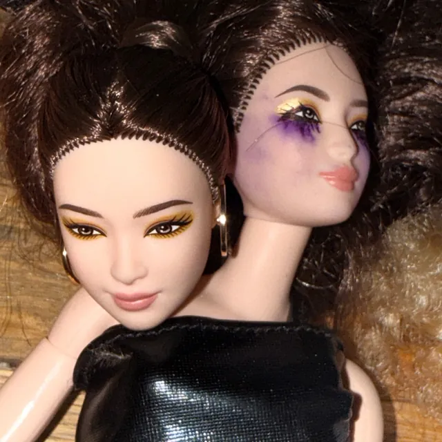 the kill cover art: close-up of a two-headed fashion doll with smudged eye makeup